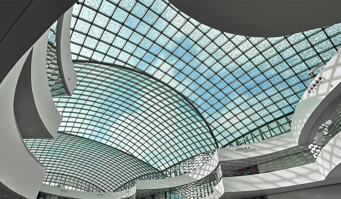 The glass roof consists of 1,854 geometrically different glass elements with a dotted frit pattern.