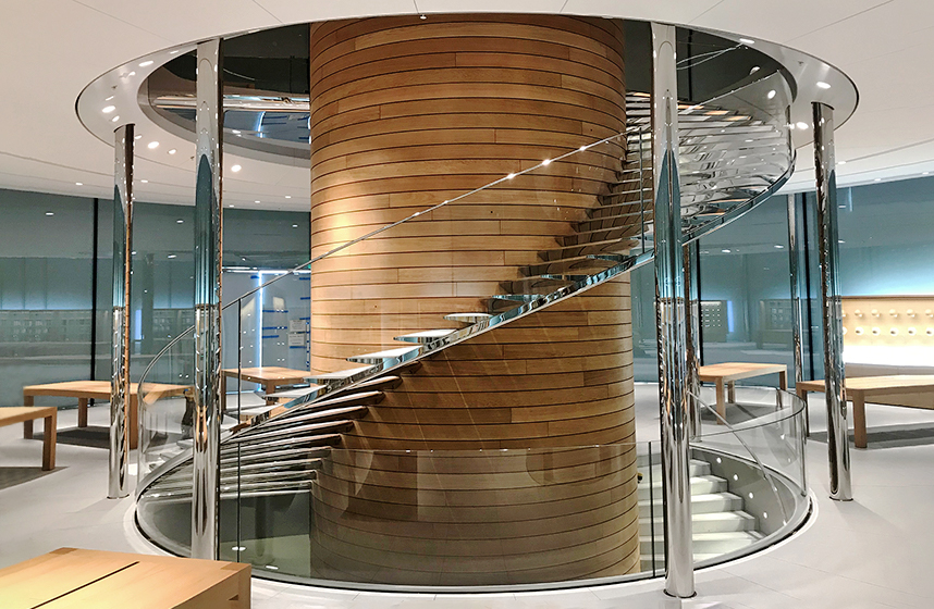 Spiral staircase made of steel, glass, wood and mirror polished stainless steel for Apple Central World made by seele.